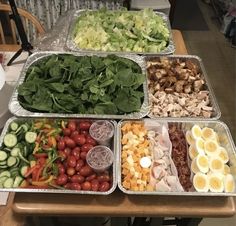 several trays filled with different types of food