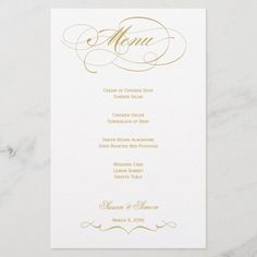 a menu card with gold foil lettering on white paper, featuring an elegant script and calligraphy