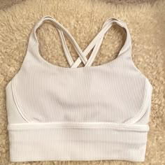 This Is Brand New. I Removed The Tag Bc I Thought It Would Fit. But Unfortunately This One Runs Small. It Fits If You Usually Wear Size 32a - 34a. White Top With Seamless Construction For Light Exercise, White Tops For Light Exercise With Seamless Construction, White Seamless Tops For Light Exercise, White Sports Bra With Light Support For Spring, White Light Support Sports Bra For Spring, Casual White Compression Sports Bra, Casual White Sports Bra For Light Exercise, White Stretch Activewear For Relaxation, Sporty Spring Activewear For Relaxation