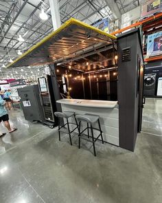 an outdoor bar with stools and tables in a warehouse or showroom for sale