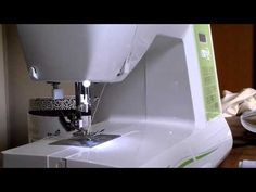 a white sewing machine sitting on top of a table