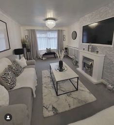 a living room filled with furniture and a flat screen tv mounted on the wall above a fire place