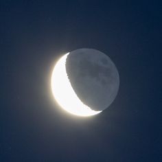 the moon is seen in front of a dark blue sky with no clouds on it