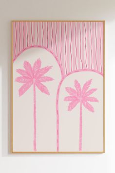 a pink palm tree on a white background in a wooden frame hanging on the wall