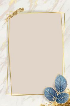 a gold frame with blue leaves on a white marble background and golden glitters around it