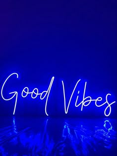 the word good vibes written in neon lights