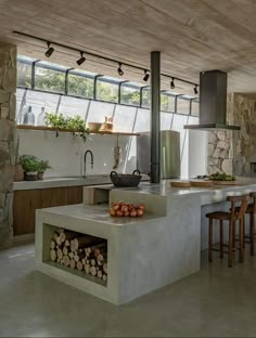 a kitchen with a stove, counter and chairs