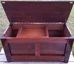 an old wooden chest sitting in the grass