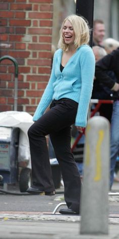 a woman riding a skateboard down a street