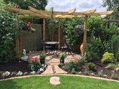 an outdoor patio and garden area is shown in this backyard setting, complete with a pergolated trellis