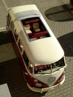 an overhead view of a red and white bus parked on the side of the road