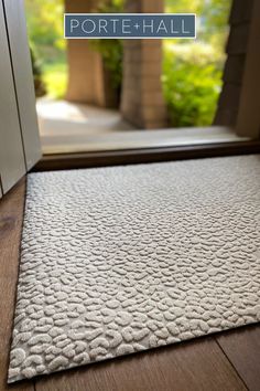 a door mat that is on the floor in front of an open door with text overlaying it