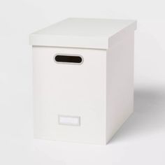 a white box with a black handle on the side and a small hole in the front