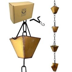 a lamp that is attached to a chain and has a box on top of it