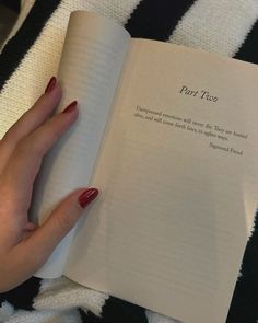 a woman's hand holding an open book with the title part two on it