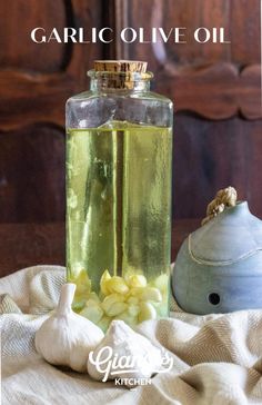 garlic oil in a glass bottle next to some garlic