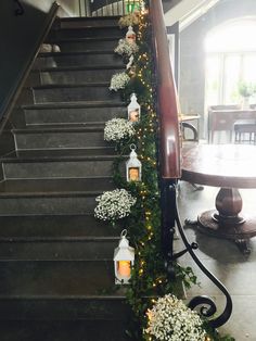 some white flowers and candles are on the stairs