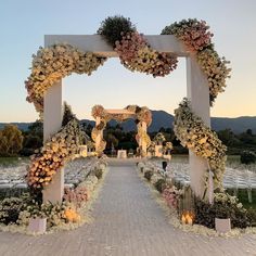 an outdoor wedding setup with flowers and candles