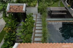 an aerial view of a small garden and pool