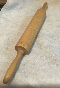 a wooden rolling pin sitting on top of a table