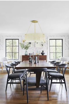 a dining room table with chairs and a chandelier