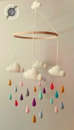 a crocheted mobile with clouds and raindrops hanging from it's sides