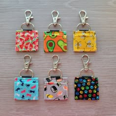 six key chains with different designs on them