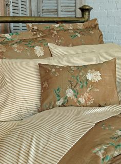 an image of a bed setting with flowers on the comforter and pillowcases