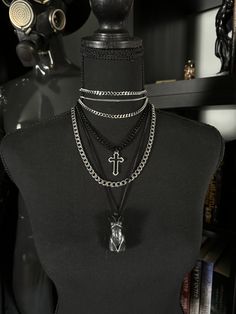 This layered gothic necklace set combines multiple textures and styles for a bold, statement-making look. Featuring silver and black chains, a cross charm, and a unique crystal-like pendant, this piece is perfect for those who love alternative, edgy fashion. The varying chain lengths create a tiered effect, giving the necklace a dynamic and layered aesthetic. Wear this piece to elevate any outfit, whether casual or formal, and embrace its dark, elegant vibes. Material: Chain: 304 stainless steel, various sizes and colors Cross Pendant: alloy Goddess Pendant: resin and aluminum wire Clasp: Lobster clasp Necklace extender: 1.5" Thank you for supporting my small business.  I am a disabled artist and your support means the world to me! Gothic Black Necklace With Silver Chain, Black Punk Jewelry With Chunky Chain, Edgy Black Jewelry With Silver Chain, Punk Black Necklace With Silver Chain, Edgy Metal Cross Jewelry, Punk Black Cross Necklace, Black Punk Cross Necklace, Edgy Metal Cross Necklace, Punk Black Chain Necklace With Silver Chain