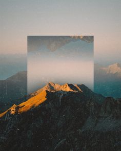 the mountains are covered in fog and low lying clouds, with a square frame over them