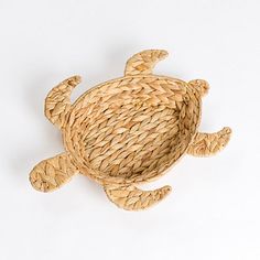 a sea turtle made out of straw on a white background