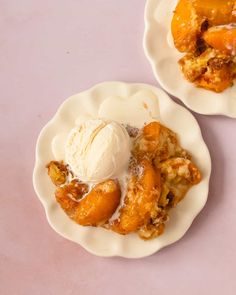 two white plates topped with desserts on top of a table