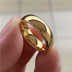 a person holding a gold wedding ring in their hand with the words,'i love you