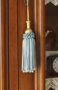 a clock and tassel hanging from a wooden door