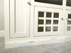 a white cabinet with glass doors on it