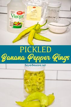 pickled banana pepper rings in a glass jar with ingredients around it on a white countertop