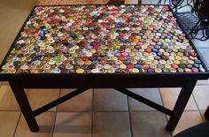 a coffee table made out of many different bottle caps