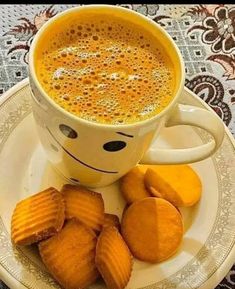 a cup of coffee and some cookies on a plate