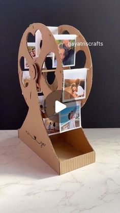 an open cardboard box with pictures on it and a video camera attached to the side