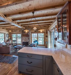 a kitchen and living room in a log cabin