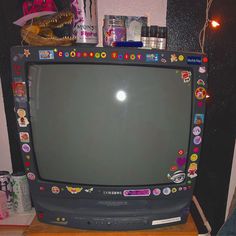 an old television with many stickers on it