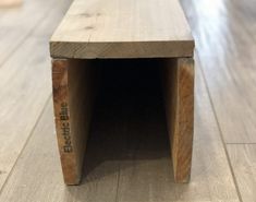 a wooden bench sitting on top of a hard wood floor