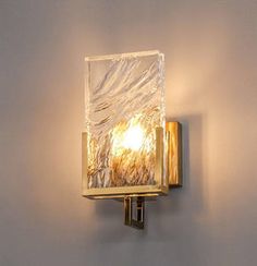 a light that is on the side of a wall with a glass block in it