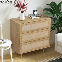 a white chair sitting next to a wooden dresser with drawers on it's sides