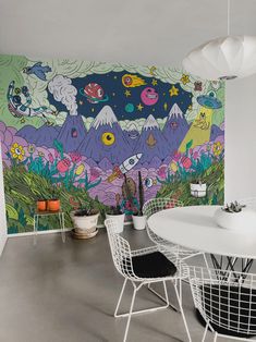 a dining room with a large mural on the wall