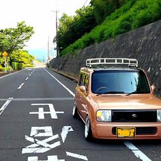 a car parked on the side of a road with an arrow painted on it's side