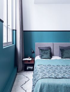 a bedroom with blue walls and white carpet