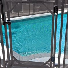 an empty swimming pool next to a metal fence