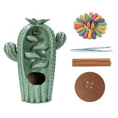 a cactus plant is next to some crafting supplies