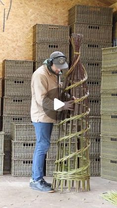 a man standing in front of stacks of wicker baskets with a mask on his face